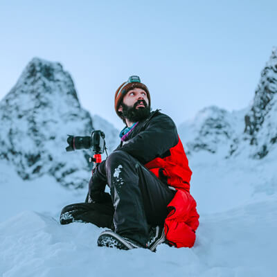 guide sitting on the snow in Norway during fjord tour